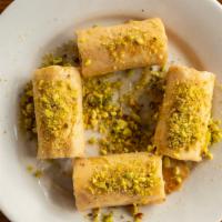 Baklawa · Ground walnuts rolled in flaky filo dough, drizzled with simple syrup and sprinkled with gro...