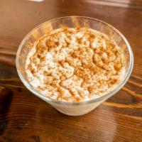 Riz Bi Haleb (Rice Pudding) · Lebanese rice pudding, drizzled with simple syrup and sprinkled with cinnamon.