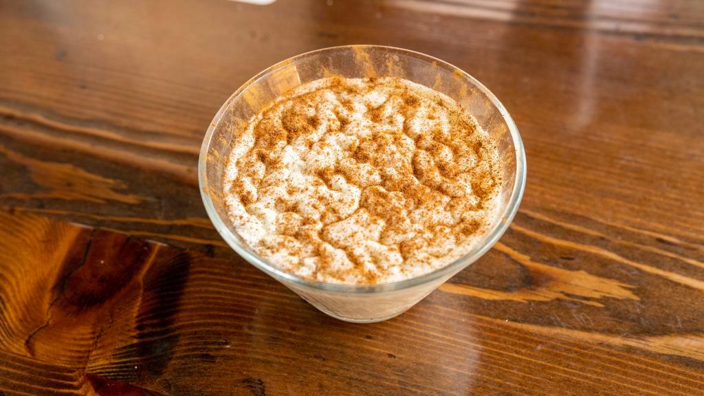 Riz Bi Haleb (Rice Pudding) · Lebanese rice pudding, drizzled with simple syrup and sprinkled with cinnamon.