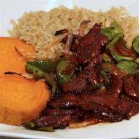 Zesty Steak · Lean steak with onions and peppers over sweet potatoes and brown rice with bbq sauce.