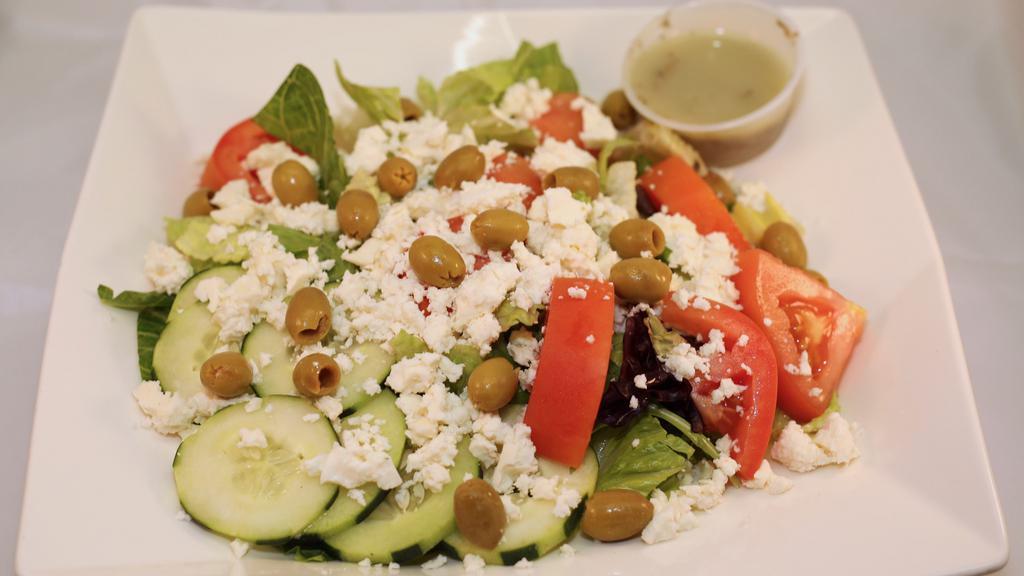 Greek Salad · Mixed greens, romaine lettuce, black olives, Feta cheese, lemon, home made seasoning, olive oil and vinegar and a choice of salad dressing.