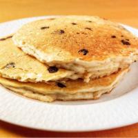 Chocolate Chip Pancakes · Stack of fluffy chocolate chip packed pancakes served with butter and syrup.