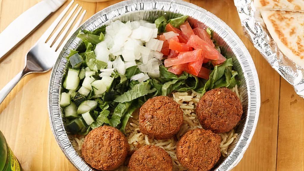 Falafel And Soda Combo Over Rice · Four huge fresh falafel balls with basmati rice and veggies and white sauce and specialty hot sauce and served with a free choice of a drink soda or water.