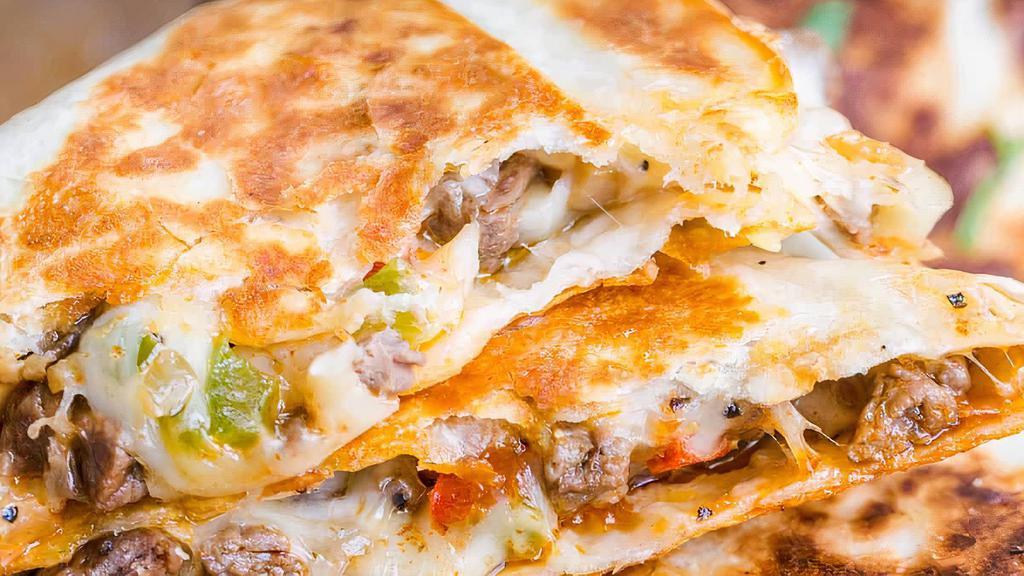 Philly Steak Quesadilla · Grilled tortilla and topped with cheese and philly steak filling! Comes with sour Cream and chipotle sauce.