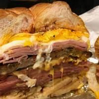 Belly Buster · 2  Eggs, Bacon, Sausage, Ham, Pork Roll, Cheese and Potatoes, all layered onto a Freshly Bak...