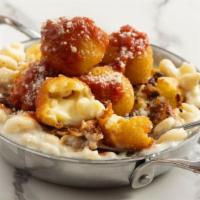 Double Down Mac & Cheese · Topped with mac & cheese fritters, parmesan tomato sauce, bacon.