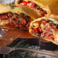 Sausage Calzone · Delicious calzone fresh out of the oven, filled with sausage & ricotta and mozzarella cheese.