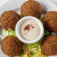 Falafel · Six pieces fried ground chickpeas with onions and herbs.
