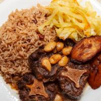 Oxtail Beef · Our  delicious oxtails meals are served with rice and peas or plain rice and cabbage and swe...