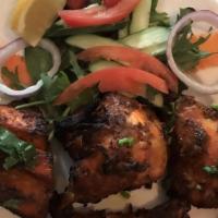 Tandoori Chicken · Tender pieces of chicken on the bone marinated with spices, herbs, ginger, and garlic paste ...