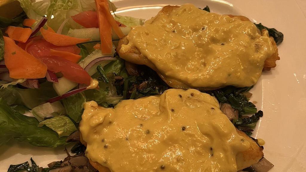 Tandoori Sea Bass · Chilean sea bass marinated with garlic, ginger, herbs and served on a bed of sautéed spinach topped with delicately spiced fresh made mustard sauce and grilled mushrooms.