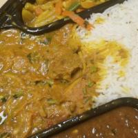Goat Curry · Tender cubes of goat curry sautéed in onions and slow-cooked in a tomato-based curry made of...