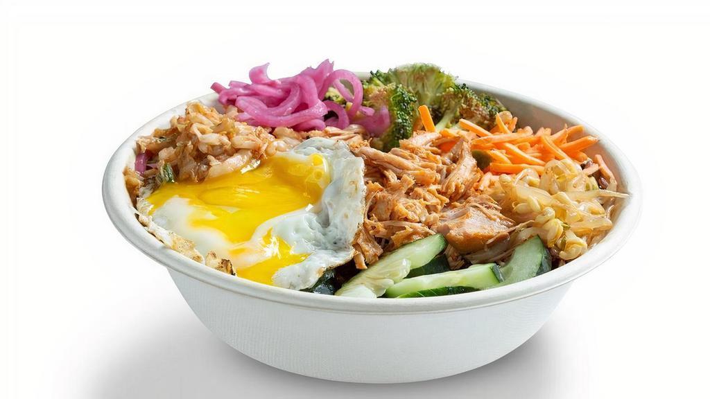 Korean Bbq Pork Warm Rice Bowl · Purple rice, kimchi, cucumbers, spicy broccoli, carrots, sriracha sprouts, fried egg, slow-roasted pork. (egg, soy). Suggested with Korean BBQ sauce. (soy)