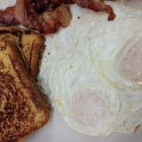 Two By Three French Toast · Two eggs, short stack of French toast and 2 Bacon or 2 Sausage