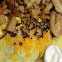 Texas Omelet · Stuffed with our homemade chili and topped with Cheddar cheese and sour cream.with Toast