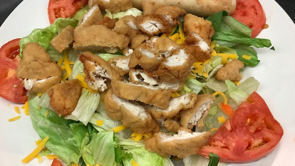 Fried Chicken Strips Salad · Fried chicken strips, lettuce, tomatoes, Cheddar cheese.