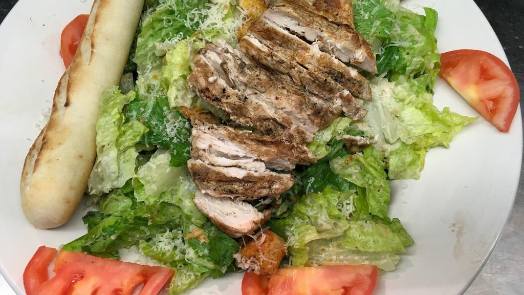 Caesar Salad With Chicken · Crisp romaine lettuce, tomatoes, homemade croutons, Parmesan cheese and a fresh breadstick.