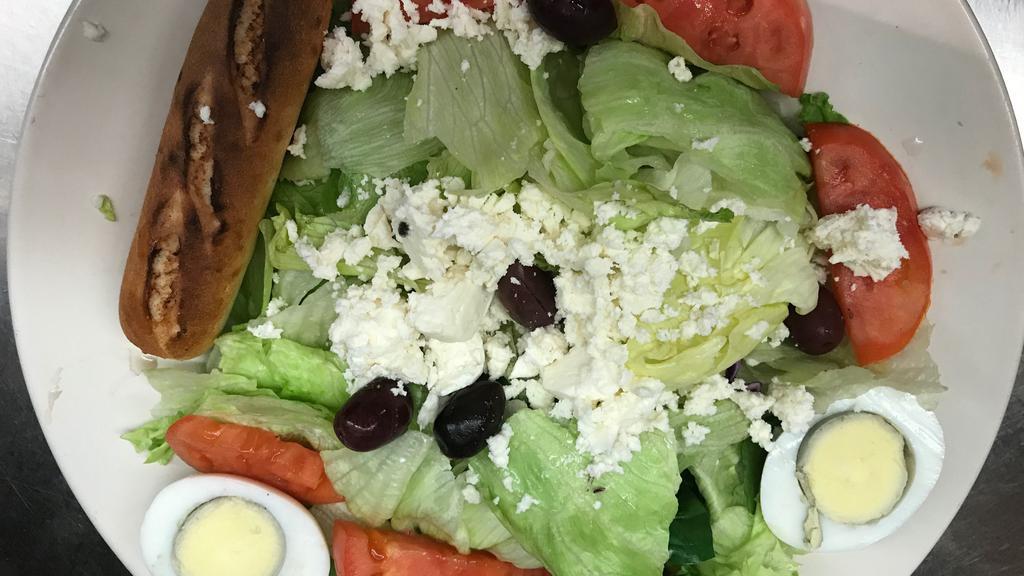 Large Greek Salad · Fresh greens, olives, Feta cheese, egg and tomato with our special greek dressing and a fresh breadstick.