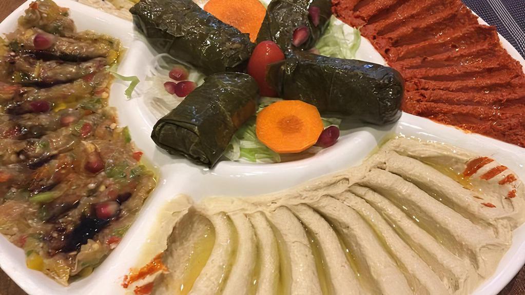 Mixed Appetizer Plate · Hummus, labneh, Baba ghanoush, spicy vegetable dip and Grape leaves