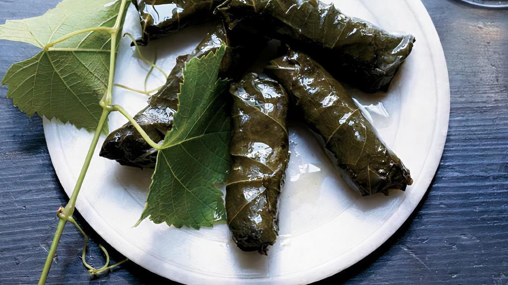 Turkish Grape Leaves · Hand rolled grape leaves stuffed with herbs & rice