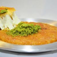 Kunefe · Cheese pastry in syrup and garnished with pistachios.