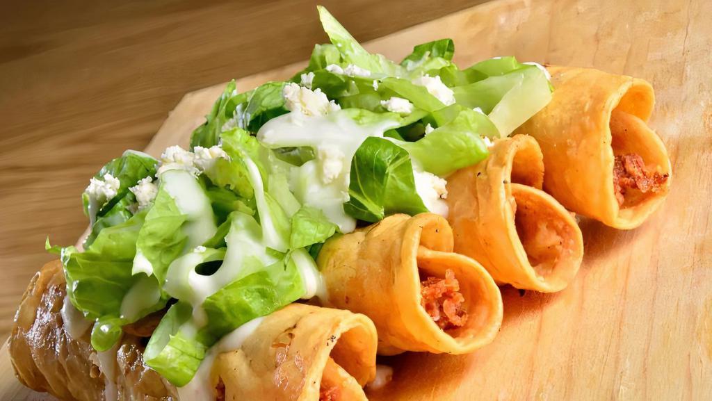Tacos Dorados · Corn tortillas with your choice of filling topped with shredded lettuce, cream and grated cheese.