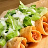 Potato Tacos Dorados · Papa corn tortillas filled with potato. Topped with shredded lettuce, cream and grated cheese.