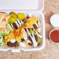 Falafel Platter · Delicious falafel platter served with rice, salad , pita bread and your of sauces.