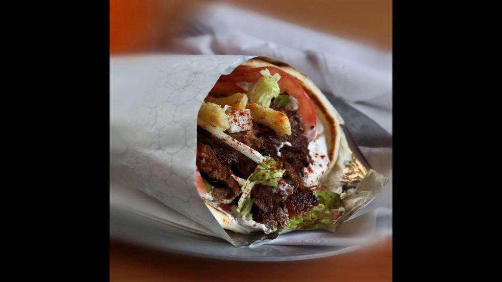 Lamb Gyro Sandwich · Lamb gyro with lettuce, tomatoes, onions, and tzatziki wrapped in a pita.
