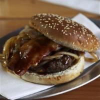 Ez Beef Burger · Beef burger served with caramelized onions, bacon, and Swiss cheese over BBQ sauce.