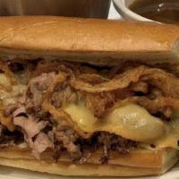 French Dip · Premium cut prime rib of beef, house smoked and hand shaved with crispy onions, horseradish ...