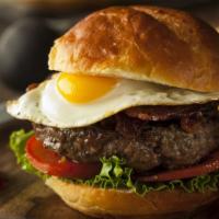 Texas Burger · Mouthwatering Burger topped with caramelized onions, lettuce, tomato and cheese with fried e...