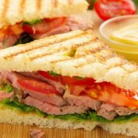 American Panini · Grilled Panini Sandwich made on a European Flatbread, and topped with Turkey, Roast Beef, Am...