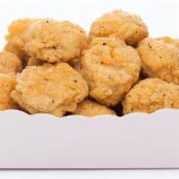 Popcorn Chicken · Bite-sized chicken pieces, battered and fried to perfection.