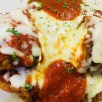 Veal Michelangelo · Veal cutlet and rolled eggplant with ricotta cheese, tomato sauce and melted Mozzarella. Ser...