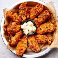 Crispy Cajun Wings · Bell & Evans wings fried in our special olive oil blend and painted with our umami soy garli...