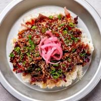 Bulgogi Ribeye Rice Bowl · Thinly sliced soy marinated USDA Choice ribeye beef over cucumbers, cabbage slaw, truffle es...