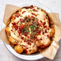 Crack Tots · Crispy tater tots with our crack sauce, bacon crumble, and chives.
