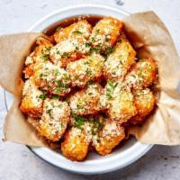 Parmesan Truffle Tots · Crispy tater tots with freshly grated parmesan cheese, white truffle oil and chives.