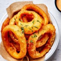 Onion Rings · Juicy white onions battered and fried to a crispy perfection served with our crack sauce.