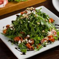 Insalata Di Rugola · Baby Arugula with Cherry Tomatoes, Pine Nuts and Goat Cheese.