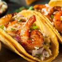 Shrimp Tacos · Aromatic shrimp tacos filled with juicy shrimp, crisp cabbage, avocado, cheese, and cilantro.