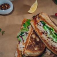 Grilled Chicken Paradiso Sandwich · House-made breed with grilled chicken breast, asiago, mozzarella, sun-dried tomato pesto, re...