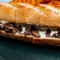 Philly Cheesesteak · Grilled steak, American or cheddar cheese, fried onions.