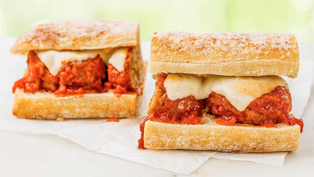 Meatball Parm (Served Hot) · Tender, Italian-style meatballs topped with our savory seasoned tomato sauce and melted mozzarella cheese served on our artisan white ciabatta roll.