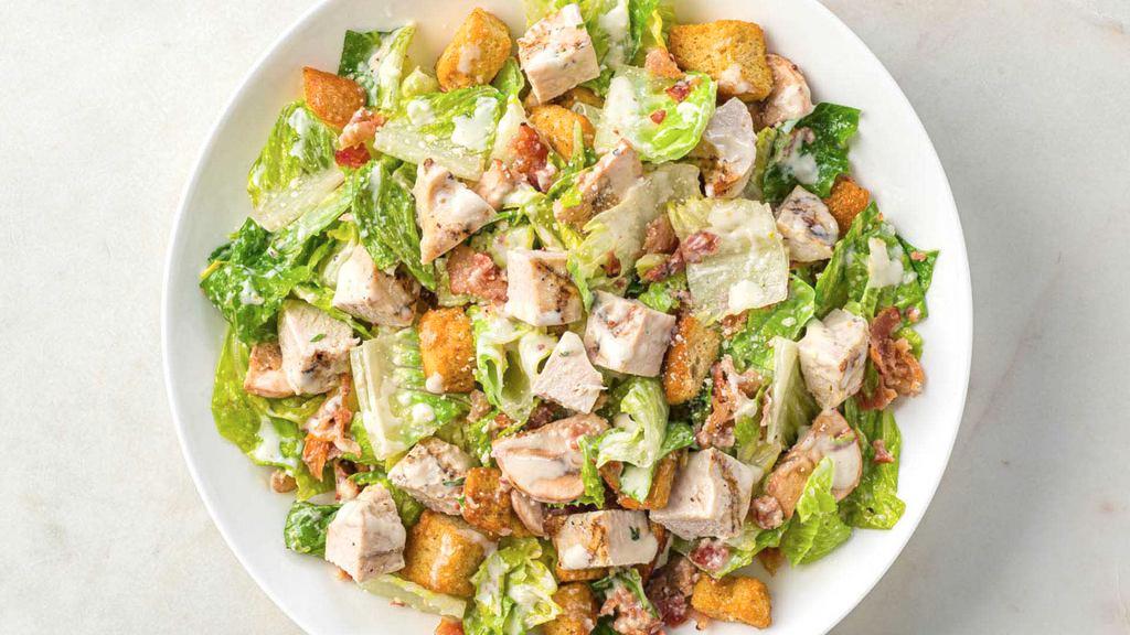 Large Bacon And Mushroom Caesar Salad With Chicken · Fresh romaine, bacon bits, mushroom slices, grated Imported Parmigiano Reggiano (aged 24 months), croutons, and Amore Caesar Dressing; topped with grilled lemon garlic chicken.