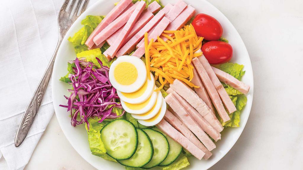 Large Chef'S Salad · Fresh romaine tossed with 97% fat-free ham, 98% fat-free turkey, cucumber, hardboiled egg, grape tomatoes, red cabbage, shredded Colby cheese, and Wegmans Organic Amore Balsamic Vinaigrette Dressing.