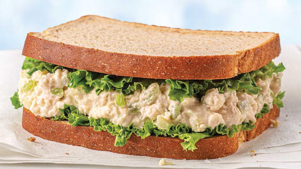 Chicken Salad Sandwich · Grilled chicken salad with fresh leaf lettuce and a pinch of Cyprus sea salt on our organic white bread.