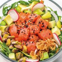 King Salmon Poke Salad · Alpine Salmon, poke sauce, avocado, and fresh veggies topped with crunchy pistachios and toa...