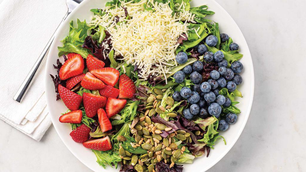 Regular Berry Blast Salad · Organic field greens topped with a variety of fresh ingredients, including flavorful strawberries, blueberries, sunflower seeds, pumpkin seeds, shredded cheddar cheese, and Wegmans Organic Amore Balsamic Vinaigrette Dressing.